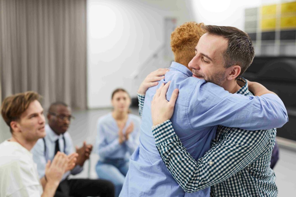 Side view  portrait of mixed race woman hugging psychologist during therapy session in support group, copy space