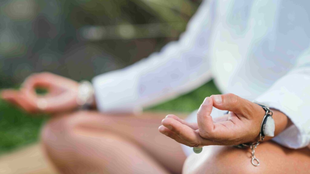 Woman meditating, balancing energy. Hands in mudra position.